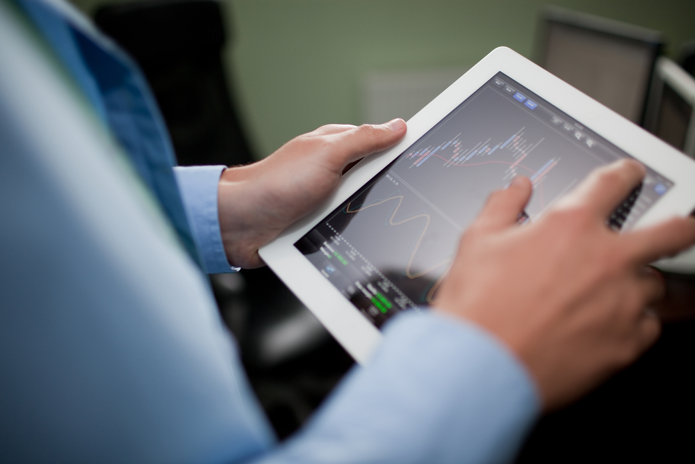 Businessman-checking-stock-market-on-tablet